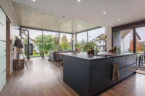 a large kitchen with a large island in a house at Helle Lichtdurchflutete Wohnung in Karsau