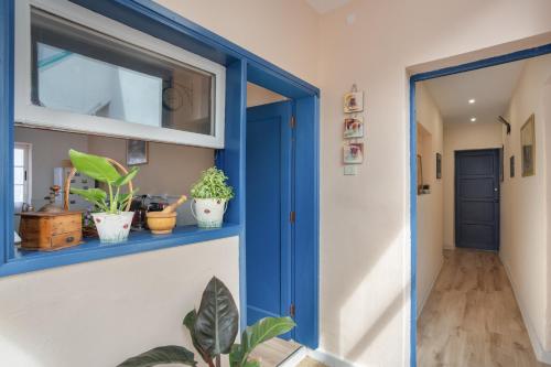 a blue door in a hallway with potted plants at Un jardin al mar in Genovés