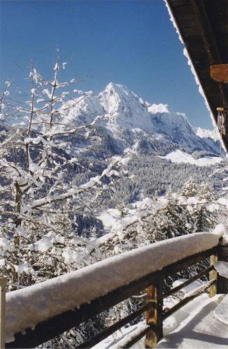 a view of a snow covered mountain from a balcony at Gstaad Paradise View Chalet with Jacuzzi in Rougemont