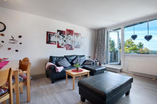 a living room with a couch and a table at Ferienwohnung Manuela in Sankt Englmar