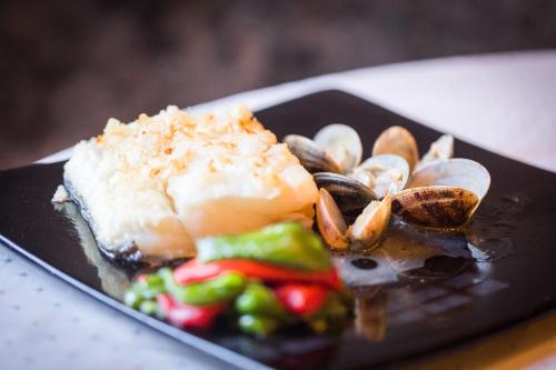 a plate of food with seafood and vegetables on a table at Hotel Larrañaga in Azpeitia