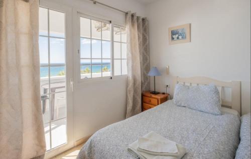 a bedroom with a bed and a view of the ocean at Flat3-5 Chaparil Beach in Nerja