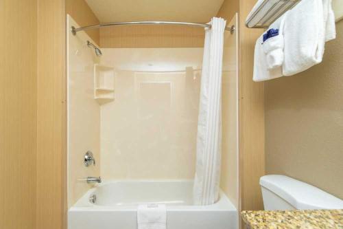 a bathroom with a shower and a tub and a toilet at Port of Kimberling Resort & Campground in Kimberling City