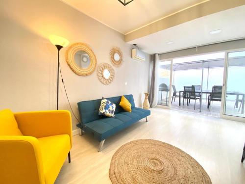a living room with a blue couch and a table at Casa Mané - Central apartment in Carvoeiro in Carvoeiro