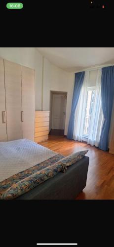 1 dormitorio con 1 cama con cortinas azules en Apartment suite in Brera, en Milán