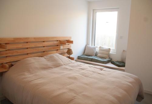 une chambre avec un grand lit et une fenêtre dans l'établissement Villa Wax - Pool & Surf, à Santec