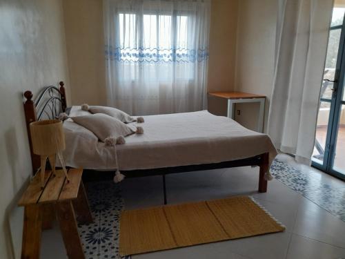 a bed in a room with a window at le Doux refuge 2 in Essaouira