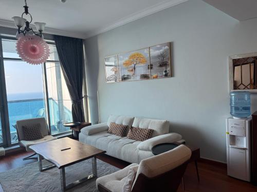 a living room with a couch and a table at sand and beach haven at Ajman Corniche! in Dubai