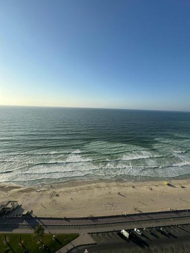 a view of the ocean from a beach at sand and beach haven at Ajman Corniche! in Dubai