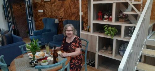 a woman sitting at a table in a room at Alakamandava in Colombo