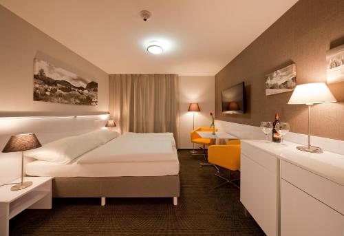a hotel room with two beds and a desk at Top Penzión Marína in Dolný Kubín