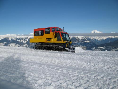 a yellow bulldozer on top of a snow covered mountain at Mica Mountain Lodge & Log Cabins in Tete Jaune Cache