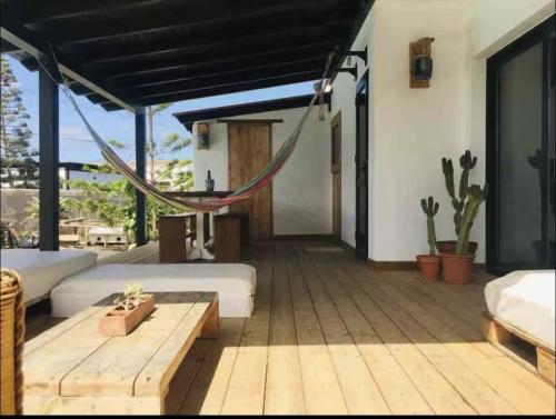 a room with a hammock and a wooden deck at Villa Ballena in Lajares