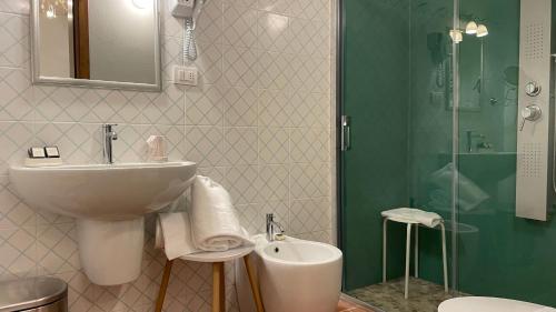 a bathroom with a sink and a toilet and a shower at Ca' Virginia Country House Wellness in Montecalvo in Foglia