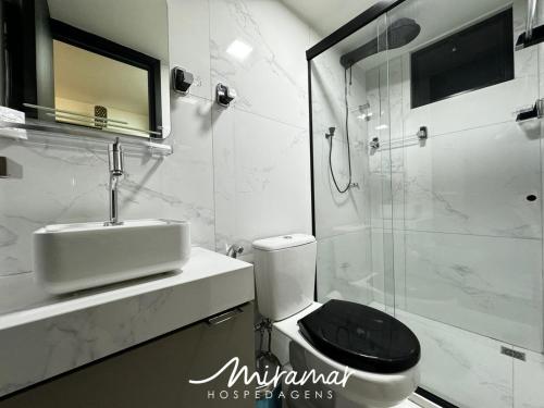 a bathroom with a toilet and a sink and a shower at Move - Tambaú in Tambaú