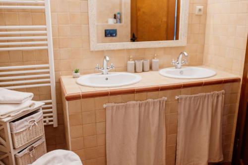 a bathroom with two sinks and a mirror at Chata Hana Donovaly in Donovaly