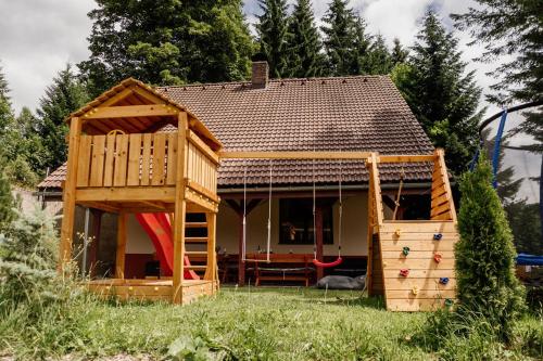 a small house with a play room and a playground at Chata Hana Donovaly in Donovaly