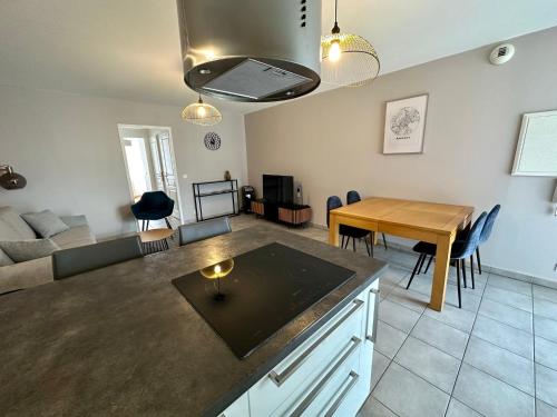 une cuisine et un salon avec une table et un canapé dans l'établissement Bel appart, le petit Carnot, à Annecy