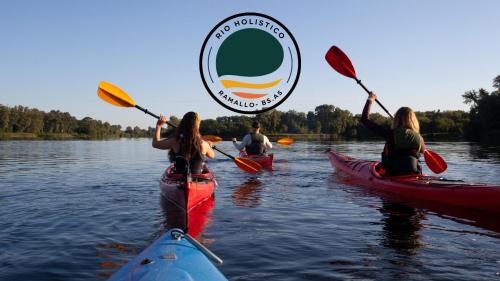 a group of people kayaking on a lake at Rio Holístico cuádruple Agua in Ramallo
