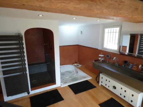 a bathroom with a shower and a sink and a tub at Villa Provençale - Rognes campagne d'Aix en Provence in Rognes