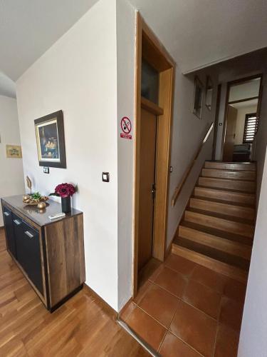 a hallway with a staircase and a door in a house at Premium Apartment in Fojnica