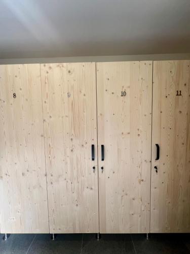 a row of wooden lockers in a room at Golden Ridge Apartments in Špindlerův Mlýn