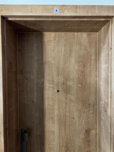 a door to a room with a wooden wall at Golden Ridge Apartments in Špindlerův Mlýn