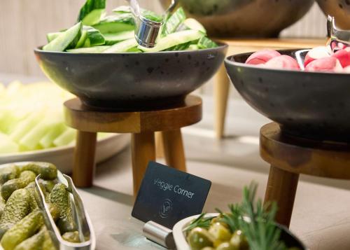 a display of bowls of vegetables on a table at Radisson Blu Hotel Zurich Airport in Kloten