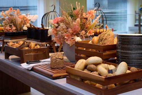 a table with baskets of bread and other foods at Radisson Blu Hotel Zurich Airport in Kloten