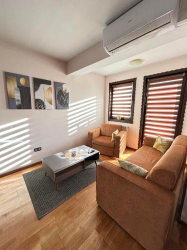 a living room with a couch and a coffee table at Premium Apartment in Fojnica