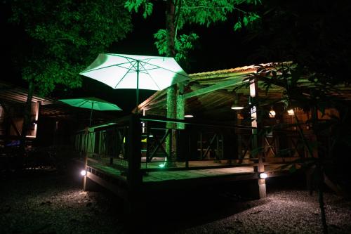 a building with an umbrella in the dark at La Martina Ecolodge in Nuquí