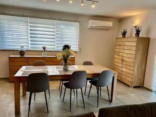a dining room with a wooden table and chairs at Loft de Waroux in Awans