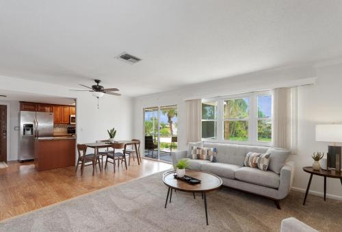 a living room with a couch and a table at Beach Bungalow by Sun Palace Vacations in Fort Myers Beach