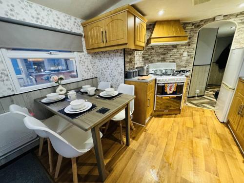 a kitchen with a table and chairs in a room at Golden Sands Holiday Home in Skegness