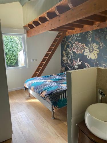 a bedroom with a bunk bed and a staircase at La Jarria in Jurançon