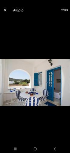 a picture of a dining room with a table and chairs at Lovely House Infront Of The Beach In Molos in Molos Parou