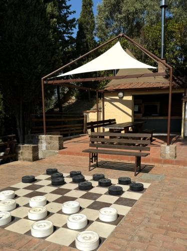 a chess board and a bench in a park at Madonna Del Poggio CAV in Scarlino