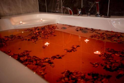 a bath tub filled with a bunch of red flowers at HASUNİ TAŞ HOTEL in Diyarbakır