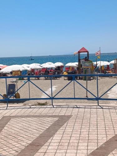 a beach with tables and umbrellas on the beach at Appartamento turistico Olivella in Formia