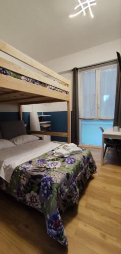 a bedroom with a bunk bed with a floral bedspread at Unmei Home in Rome