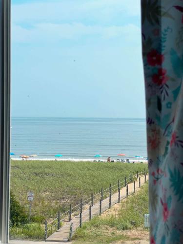 a view of a beach from a window at Ocean House Boutique Hotel & Motel in Old Orchard Beach
