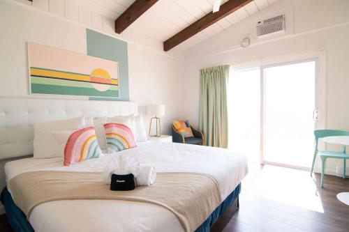 a bedroom with a large bed with a rainbow on it at Ocean House Boutique Hotel & Motel in Old Orchard Beach