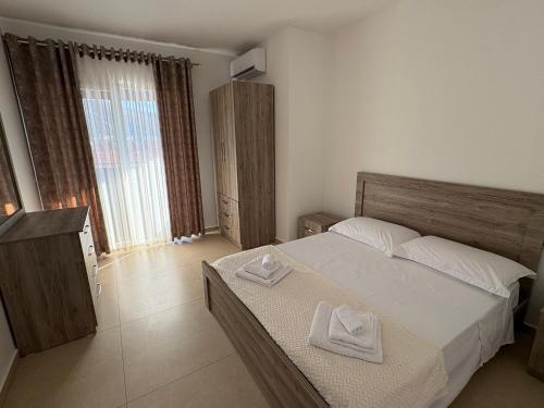 a bedroom with a bed with two towels on it at MEGAN RESIDENCE - floor 3 in Shëngjin