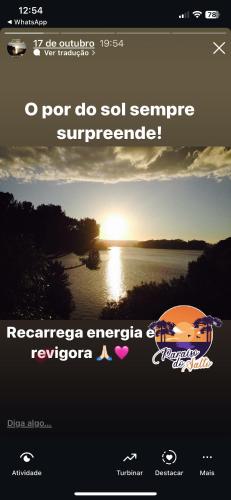 a screenshot of a website with a picture of a sunset at Paraíso do Salto in Lages