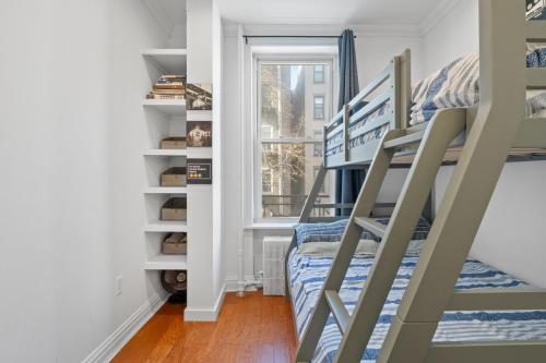 a small room with a bunk bed and a window at 15 Minutes to NYC - Large Home - Great Location in Hoboken