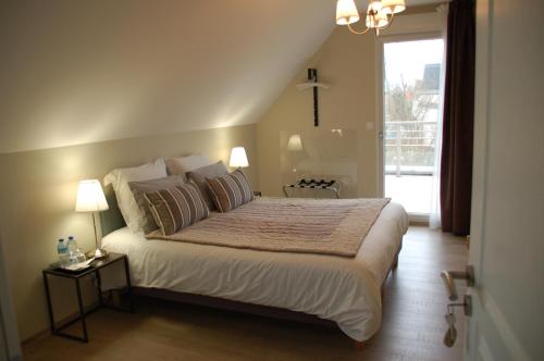Posteľ alebo postele v izbe v ubytovaní L'Alidade Chambres d'hôtes