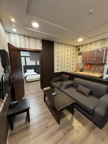 a living room with a couch and a table at Oroub El Forssan in Buraydah