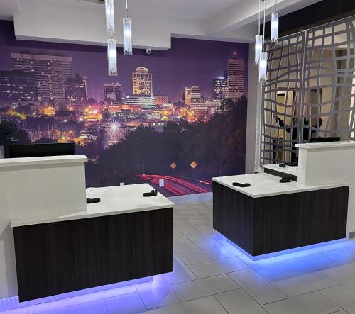 a room with a view of a city at night at La Quinta Inn by Wyndham Columbia SE Fort Jackson in Columbia