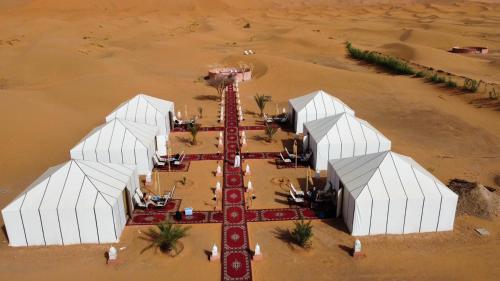an aerial view of a mosque in the desert at Alawi Dunas Merzouga Camapmento in Merzouga