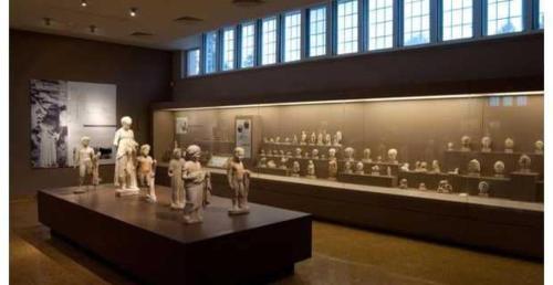 a museum with a display of figurines on a table at Superb Athens Airport Residence, Unique View in Spáta